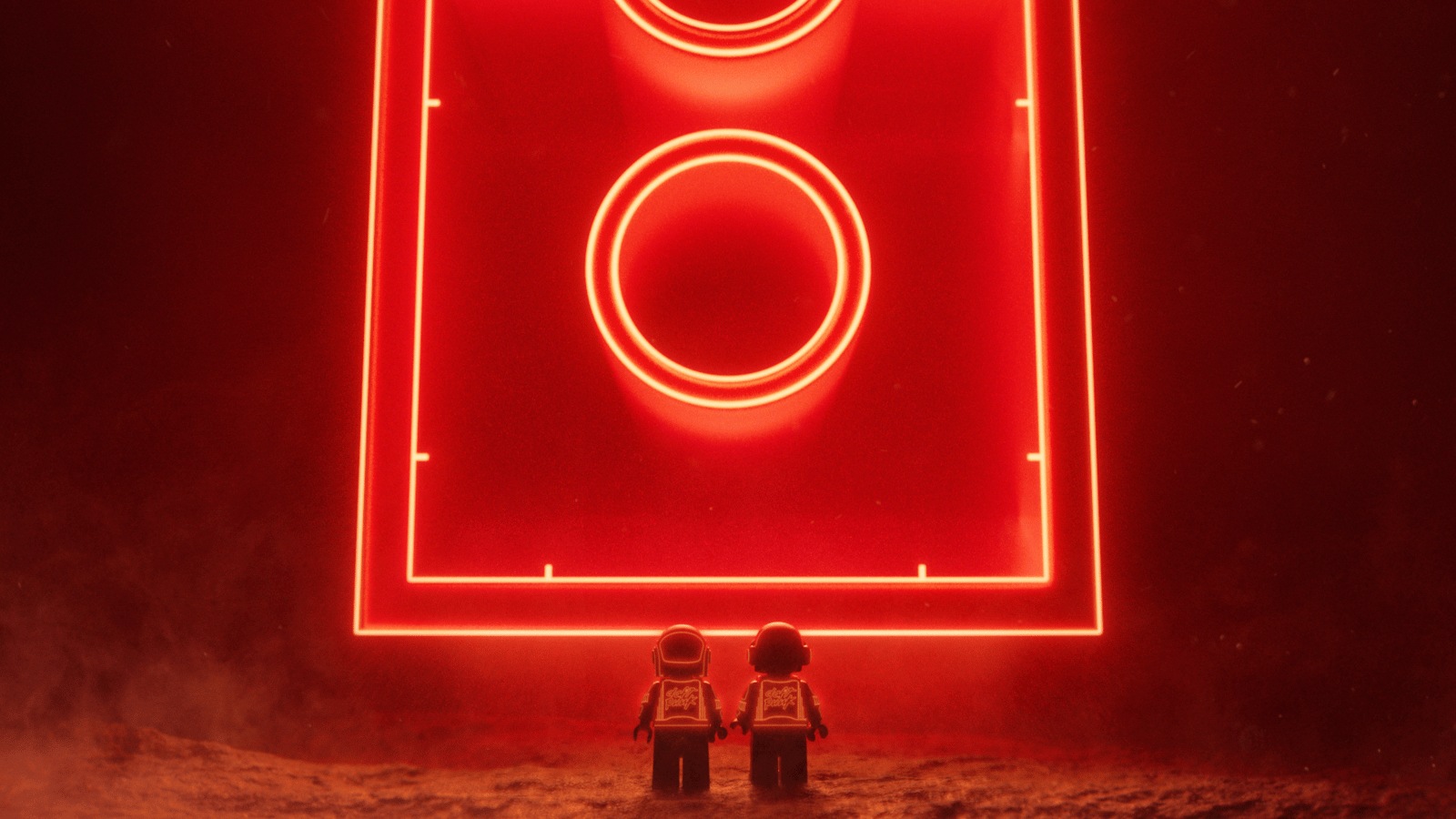 Two Lego minifigures in Daft Punk-style helmets stand before a giant glowing red Lego brick in official partnership artwork
