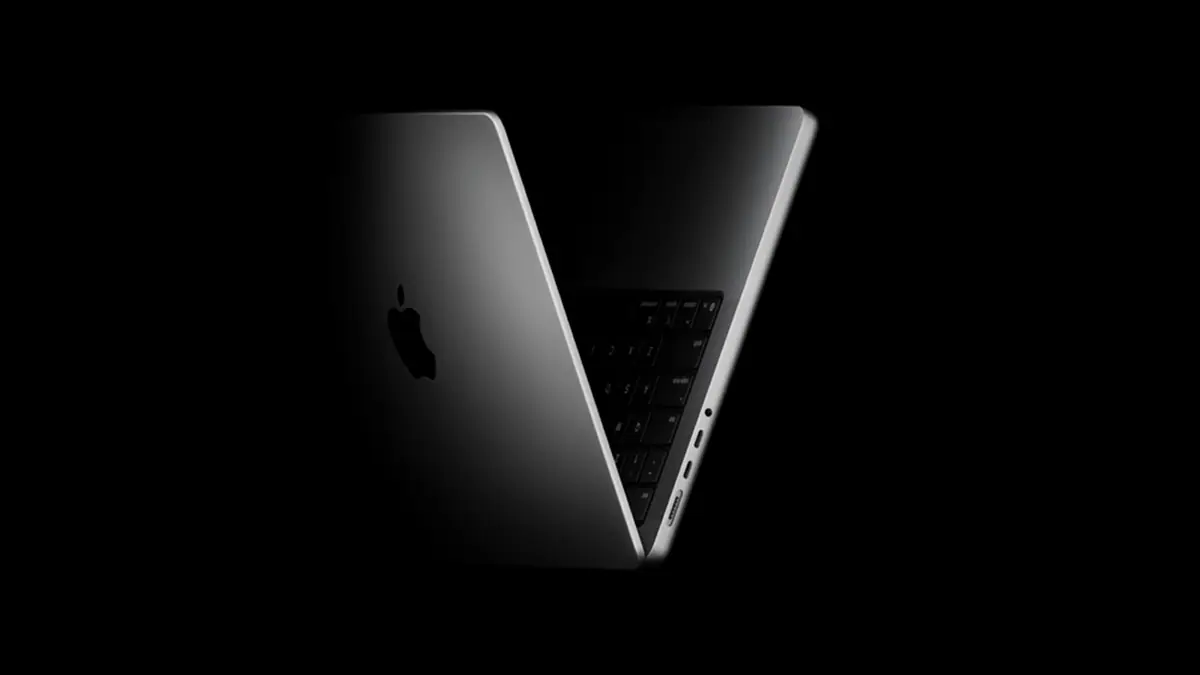 Official Apple MacBook Pro product image: a MacBook Pro half open in the dark, showing the Apple logo and keyboard