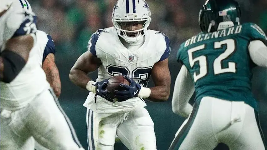 A Dallas Cowboys running back carries the ball past an Eagles defender during Monday Night Football in Philadelphia